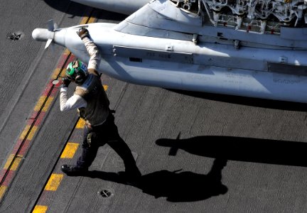 US Navy 100417-N-4236E-205 A Sailor walks next to an EA-6B Prowler assigned to the Patriots of Electronic Attack Squadron (VAQ) 140 aboard the aircraft carrier USS Dwight D. Eisenhower (CVN 69)