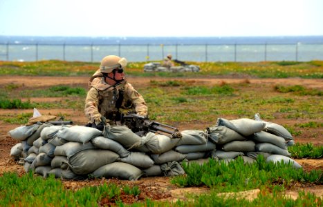 US Navy 100421-N-4965F-410 Sailors assigned to Maritime Expeditionary Security Squadron (MSRON) 3 man .50-caliber machine guns positions surrounding the perimeter of a simulated forward operating base