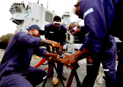 US Navy 100421-N-6138K-723 Sailors from the Sierra Leone and Togo navies perform a pipe patch during a crucible aboard USS Gunston Hall (LSD 44) photo