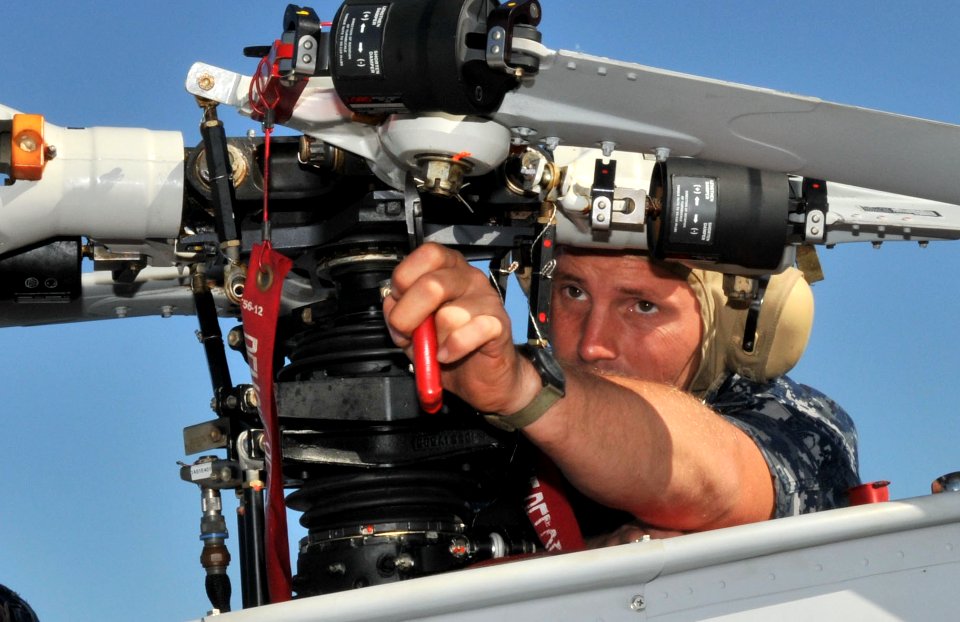 US Navy 100416-N-0486G-001 Aviation Machinist's Mate 2nd Class Scott Schinke removes a main rotor blade from one of two MQ-8B Fire Scout UAVs