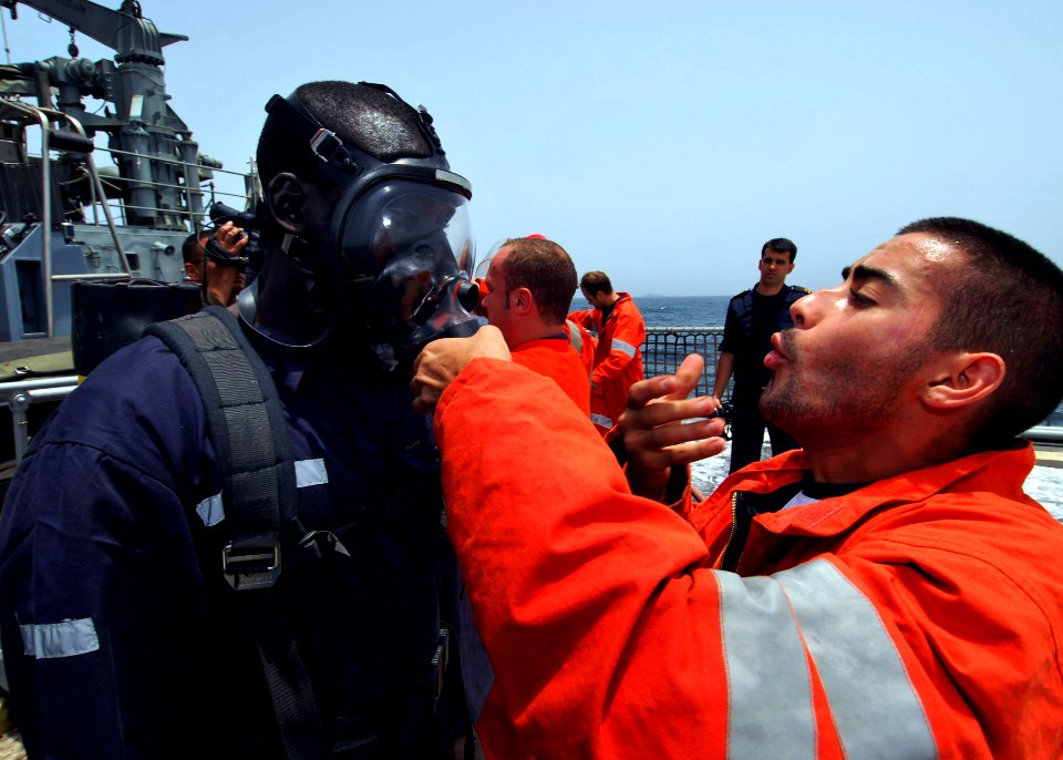 US Navy 100419-N-6138K-714 Spanish navy sailor Marinero Tomas Yanes helps Togolese navy Chief Petty Officer Kpomgbe Kouessan operate a self-contained breathing apparatus