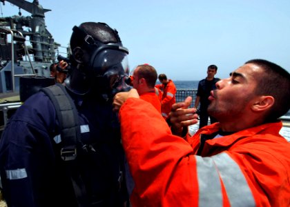 US Navy 100419-N-6138K-714 Spanish navy sailor Marinero Tomas Yanes helps Togolese navy Chief Petty Officer Kpomgbe Kouessan operate a self-contained breathing apparatus
