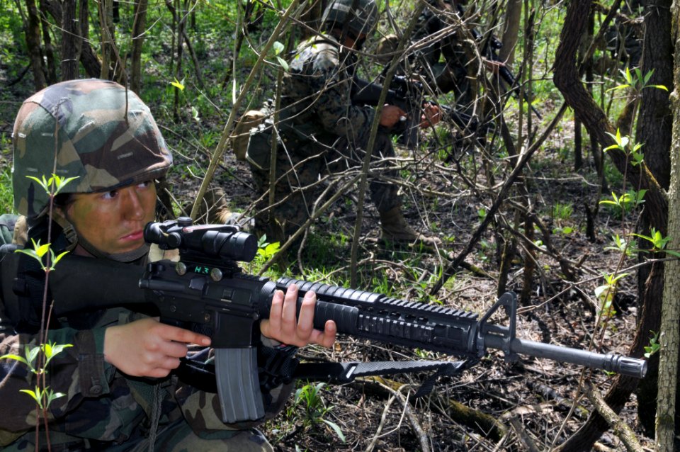 US Navy 100418-N-8848T-371 Navy ROTC Midshipman 4th Class Alex Songer, from St. Louis, patrols with her M-16A4 weapon during a field training exercise