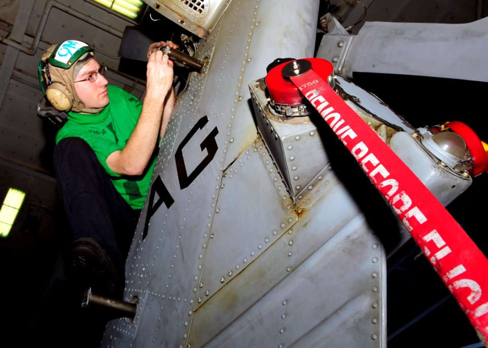 US Navy 100419-N-6935K-004 Aviation Electronics Technician 3rd Class Robert Nestlerode performs maintenance on the tail rotor of an HH-60H Sea Hawk helicopter