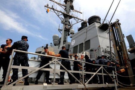 US Navy 100422-N-9818V-488 Master Chief Petty Officer of the Navy (MCPON) Rick West, center left, joins a working party aboard the guided-missile destroyer USS Arleigh Burke (DDG 51)