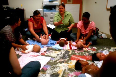 US Navy 100423-N-0641S-135 Mara MacDonald leads a group of new mothers and their babies in an infant massage class