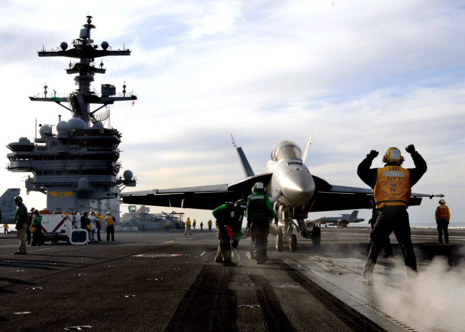 US Navy 100420-N-6509M-074 A Sailor assigned to the air department of the aircraft carrier USS George H.W. Bush (CVN 77) directs an F-A-18F Super Hornet