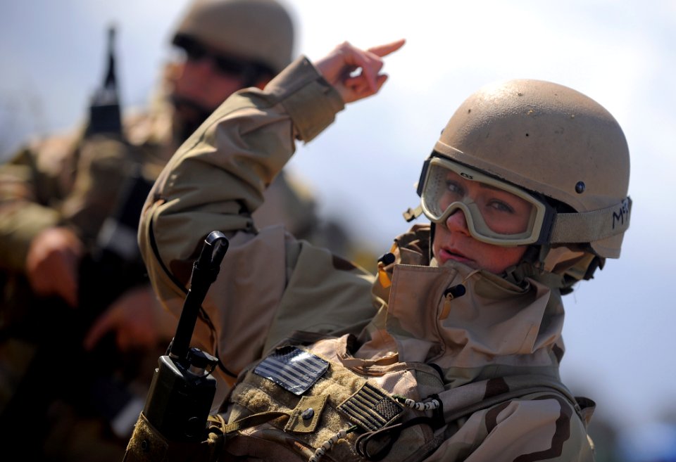US Navy 100421-N-4965F-110 Master-at-Arms 3rd Class Alyson Mills, assigned to Maritime Expeditionary Security Squadron (MSRON) 3, signals to security watch standers on a simulated forward operating base during a Navy Expedition
