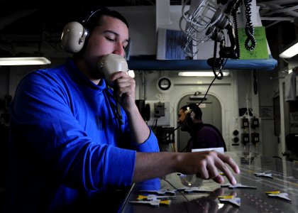 US Navy 100420-N-3885H-033 Aviation Boatswain's Mate (Handling) Airman Marco Estrada moves a spotting piece on the Ouija board in flight deck control aboard the aircraft carrier USS George H.W. Bush (CVN 77)