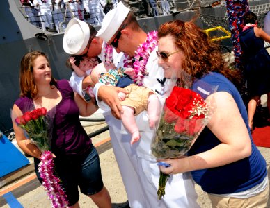 US Navy 100423-N-3666S-067 Sailors greet their newborn children upon returning to Joint Base Pearl Harbor-Hickam photo