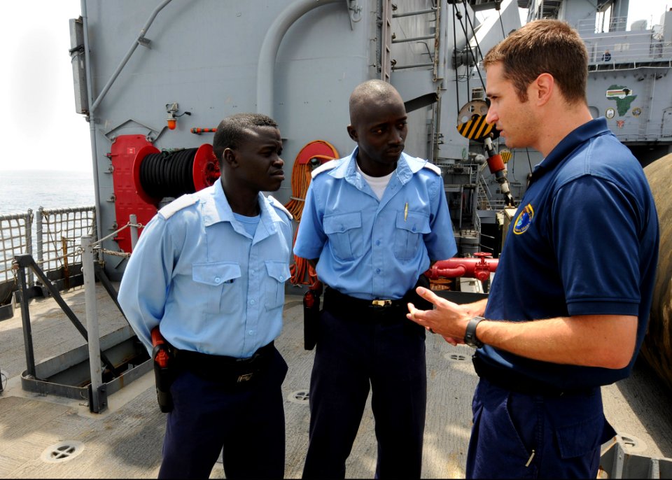 US Navy 100419-N-6676S-046 U.S. Coast Guard Maritime Enforcement Specialist 2nd Class Daniel Chase gives Gambia sailors instructions before beginning a Basic Boarding Officer Course practical exercise