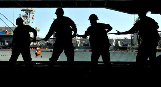 US Navy 100421-N-3595W-001 Sailors pull a line during an underway replenishment aboard the Nimitz-class aircraft carrier USS Dwight D. Eisenhower (CVN 69)