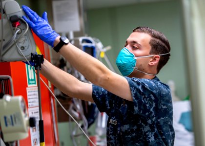USNS Mercy Sailor Treats Patient (49785699691)