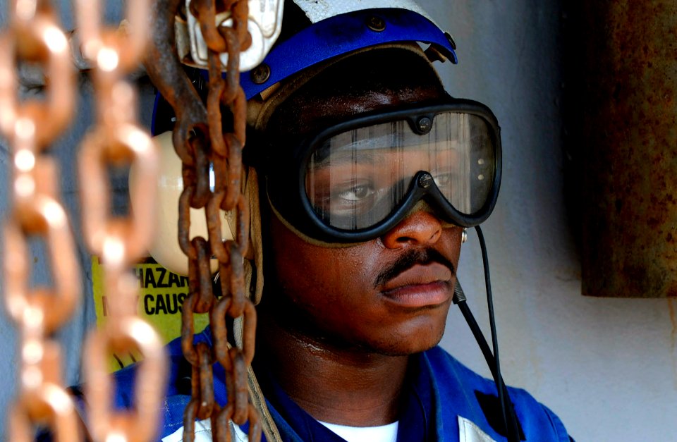 US Navy 100423-N-7478G-152 Ship's Serviceman Seaman Demarquis Holman stands watch as the phone operator aboard USS Blue Ridge (LCC 19)