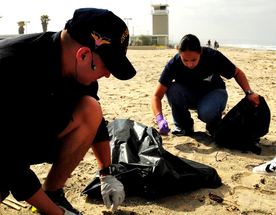 US Navy 100424-N-0808V-022 Logistics Specialist 1st Class Marcos Maldonado and Logistics Specialist 1st Class Lillian Morales olunteer during the Creek to Bay Clean-up to collect trash along Silver Strand State Beach