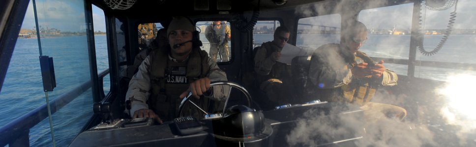 US Navy 100422-N-4965F-193 Sailors assigned to a boat detachment of Maritime Expeditionary Security Squadron (MSRON) 3 man a rigid-hull inflatable boat during a Navy Expeditionary Combat Command (NECC) integrated exercise