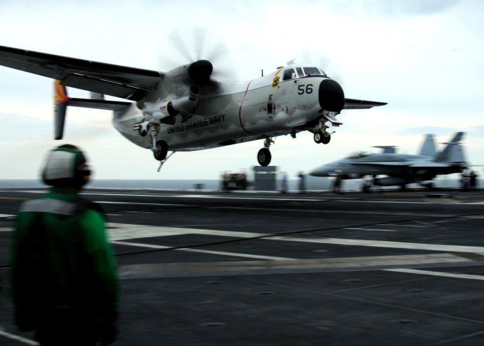 US Navy 100421-N-7908T-664 A sailor aboard the aircraft carrier USS George H.W. Bush (CVN 77) observes the landing of a C-2A Greyhound