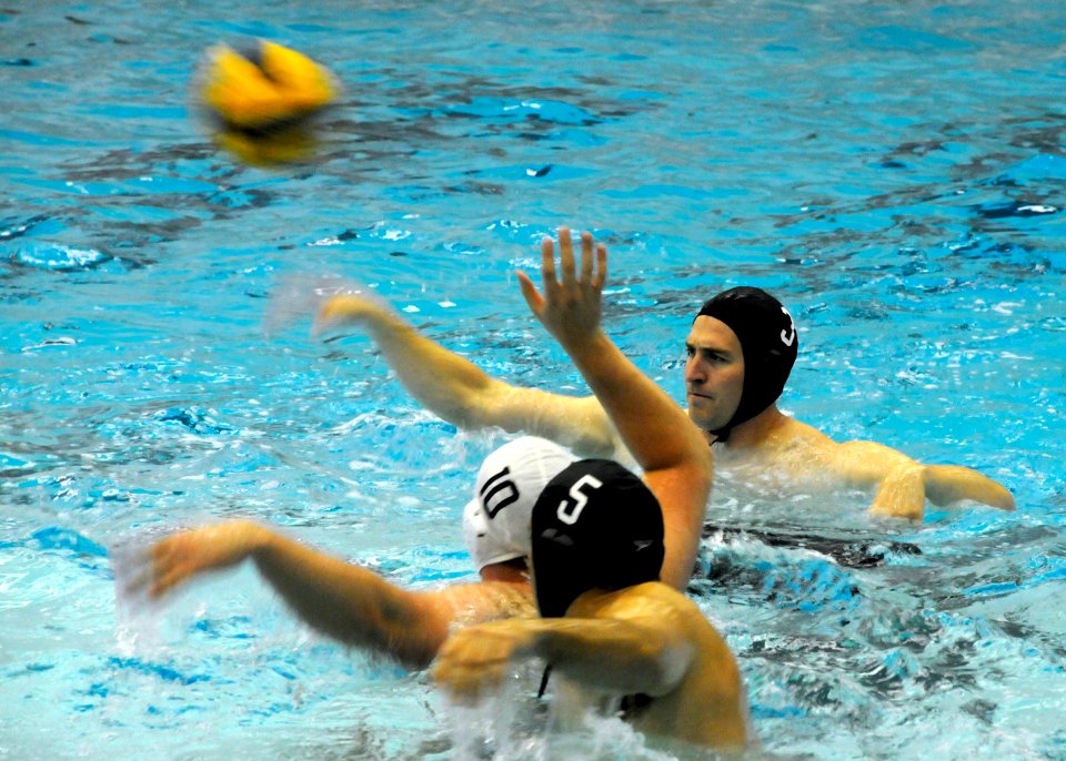 US Navy 100422-N-5366K-088 Special Warfare Operator 1st Class (SEAL) Isaiah Maring passes the ball during a water polo game with Des Moines Water Polo Club at Valley High School as part of Des Moines Navy Week