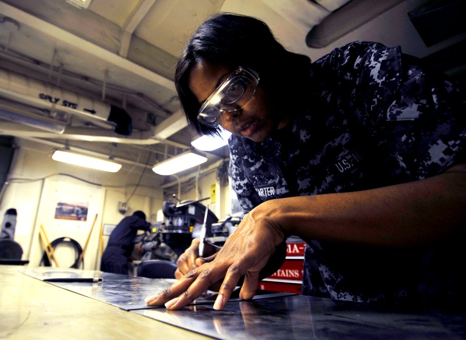 US Navy 100421-N-6003P-136 Aviation Structural Mechanic Airman Marisa Carter, from Detroit, Mich., measures metal to perform maintenance on a door aboard the Nimitz-class aircraft carrier USS Harry S. Truman (CVN 75)