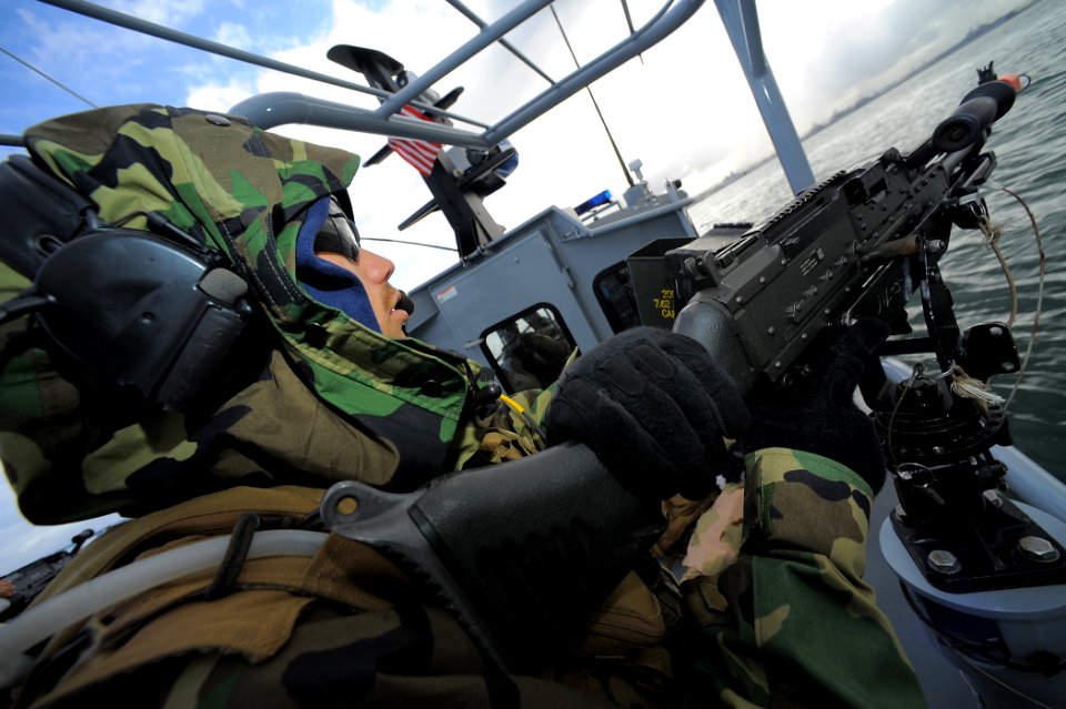 US Navy 100422-N-4965F-111 Boatswain's Mate 3rd Class Harry Crawford mans an M-240B machine gun aboard a rigid-hull inflatable boat