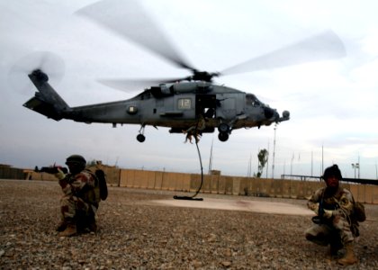 US Navy 100427-N-0879R-227 An Army Special Forces member holds on to Izra, a four-year-old German shepherd during fast-rope insertion training photo