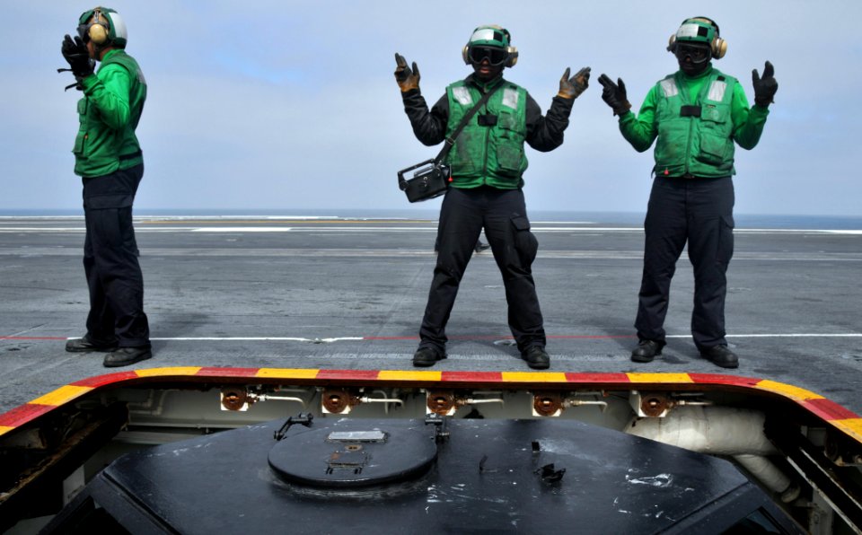 US Navy 100426-N-5749W-228 Sailors aboard the aircraft carrier USS Abraham Lincoln (CVN 72) give the safe signal to lift the