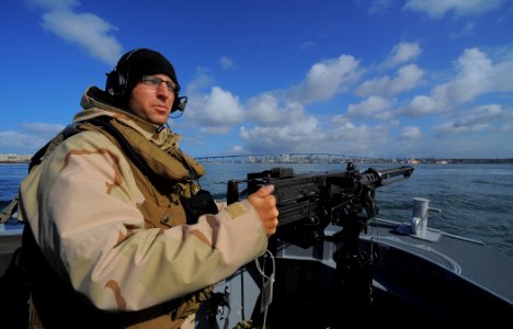 US Navy 100422-N-4965F-218 Gunner's Mate 2nd Class Ian Unterbrink, assigned to a boat detachment of Maritime Expeditionary Security Squadron (MSRON) 3, mans an M2HB .50-caliber machine gun