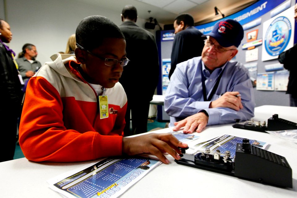 US Navy 100422-N-8863V-111 Engineer Duane Allen teaches Morse Code to a student during a Take A Child 2 Work Day event at Naval Surface Warfare Center, Corona Division