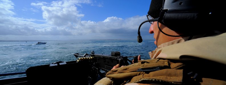 US Navy 100422-N-4965F-229 Gunner's Mate 2nd Class Ian Unterbrink, assigned to a boat detachment of Maritime Expeditionary Security Squadron (MSRON) 3, engages a simulated waterborne threat