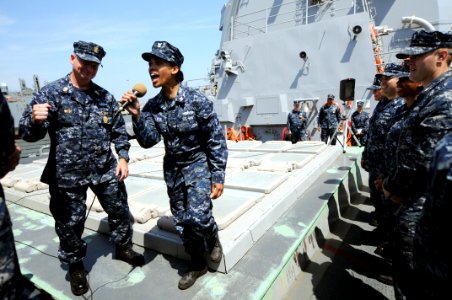 US Navy 100422-N-9818V-336 Master Chief Petty Officer of the Navy (MCPON) Rick West, left, and Gunner's Mate 2nd Class Robin Bergeron lead the crew of the guided-missile destroyer USS James E. Williams (DDG 95) in an