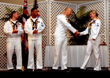 US Navy 100422-N-5476H-032 Legalman 1st Class Jessica Byard is congratulated by Navy Diver 1st Class James Bogenhagen as she is introduced as a finalist for the 2010 Pacific Fleet Shore Sailor of the Year