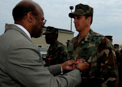 US Navy 100423-N-4267W-092 Dr. Clifford L. Stanley, Under Secretary of Defense for Personnel and Readiness, awards the Bronze Star medal to Lt. j.g. Michael Haytasingh, assigned to Explosive Ordnance Disposal Mobile Unit (EODM