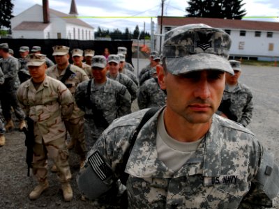 US Navy 100423-N-6538W-001 Master-at-Arms 1st Class Christopher Wells, from Springfield, Mo., stands at attention in front of his squad