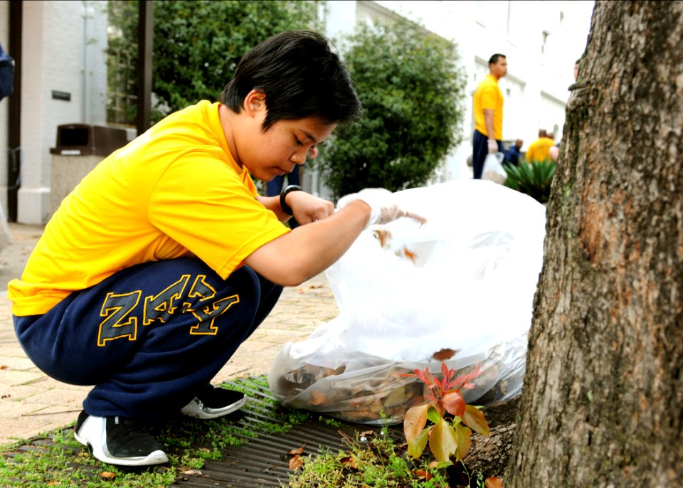 US Navy 100423-N-5538K-019 Gas Turbine System Technician (Electrical) 3rd Class Jandavy Eseque picks up refuse during a base-wide Earth Day cleaning at Commander, Fleet Activities Sasebo