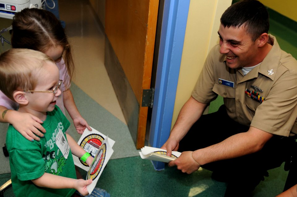 US Navy 100429-N-1522S-005 Machinist's Mate 2nd Class John Lane assigned to the Los Angeles-class submarine USS Newport News (SSN 750) visits with children at the Joe Dimaggio Children's Hospital in Hollywood, Fla., as part of