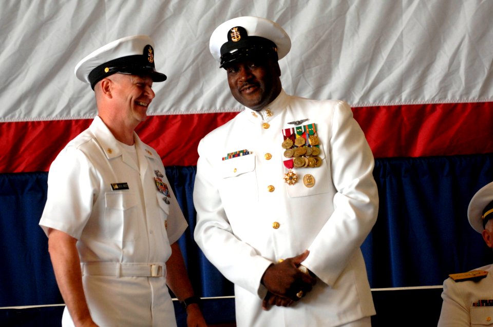 US Navy 100423-N-9818V-491 Master Chief Petty Officer of the Navy (MCPON) Rick West presents Force Master Chief Petty Officer Fred Pharr with a retirement letter during Pharr's retirement ceremony