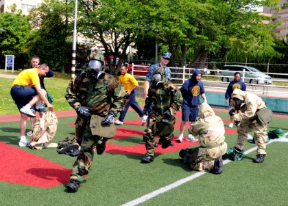US Navy 100430-N-5538K-035 ailors from Fleet Activities Sasebo don chemical, biological and radiological suits during the chemical, biological, radiological, and nuclear (CBRN) Olympics at Nimitz Park