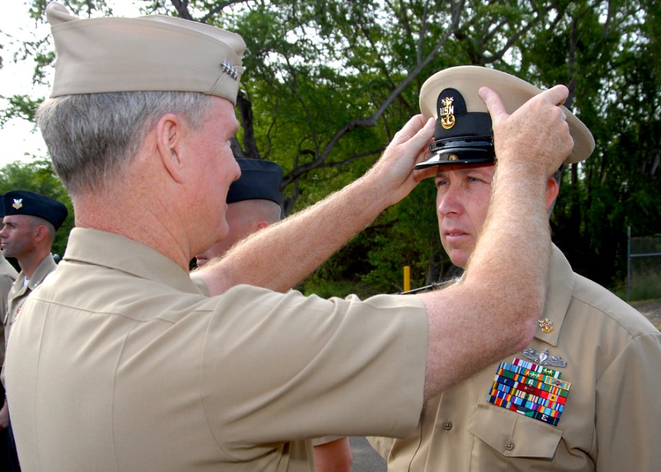 US Navy 100430-N-5476H-022 Master Chief Cryptologic Technician (Networks) Daniel Oldham is presented with his new master chief combination cover by Adm. Patrick M. Walsh, commander of U.S. Pacific Fleet, during an awards ceremo