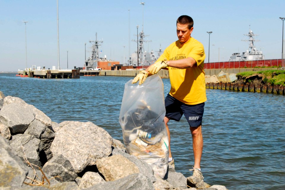 US Navy 100430-N-3154P-029 Master Chief Machinist's Mate John Dorsett, assistant officer in charge of Performance Monitoring Team, Norfolk, picks up trash by the piers at Naval Station Norfolk as part of clean the station day a