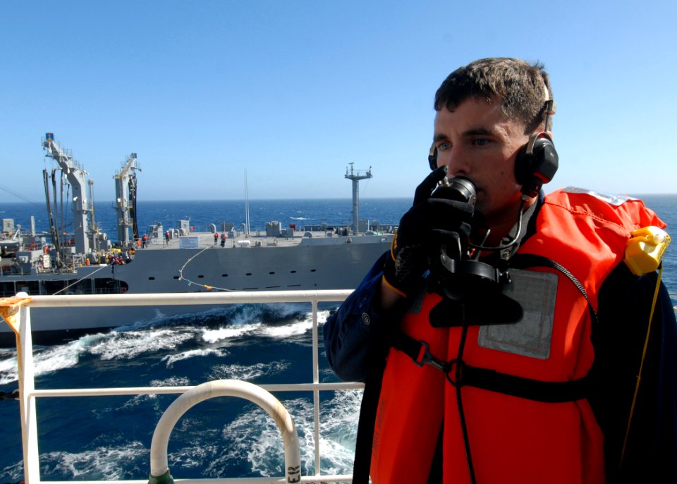 US Navy 100501-N-0209M-008 Logistics Specialist 2nd Class Stephen Hallerman uses a sound-powered phone to communicate to the bridge