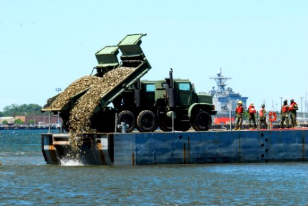 US Navy 100428-N-3154P-149 Sailors assigned to Amphibious Construction Battalion (ACB) 2, use heavy machinery to load oyster shells for two new artificial oyster reef sites in the mud flats of Little Creek Cove