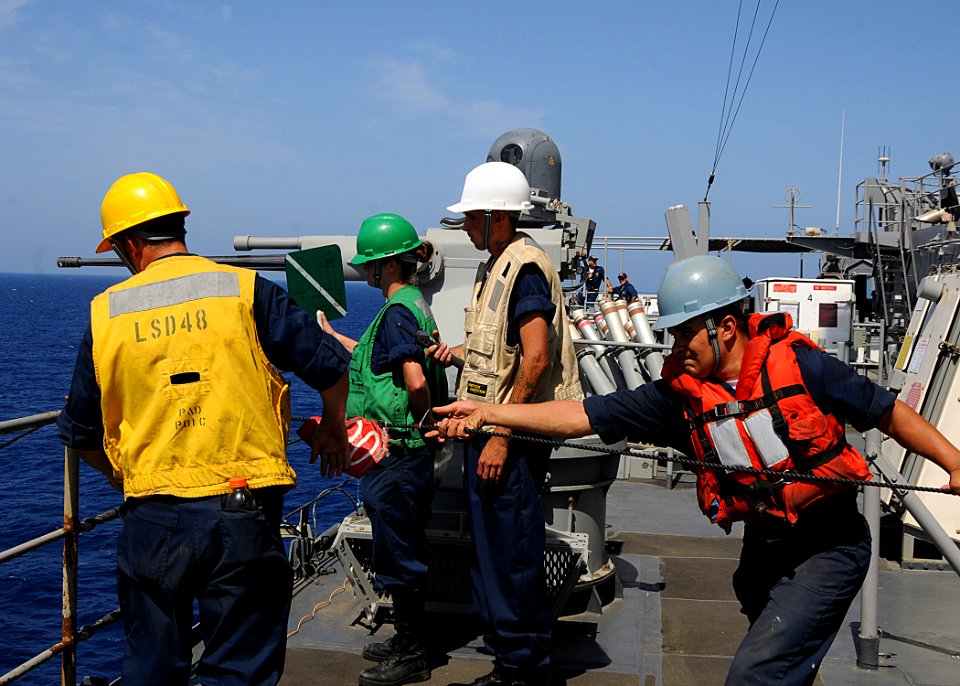 US Navy 100427-N-1082Z-024 Sailors handle the phone and distance line and communicate via paddles aboard the amphibious dock landing ship USS Ashland (LSD 48) during a replenishment at sea