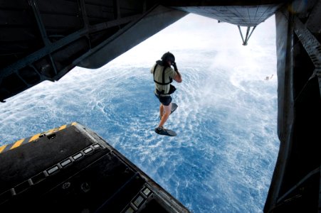 US Navy 100501-N-7526R-064 An Air Force pararescueman jumps from a CH-53E Super Stallion helicopter photo