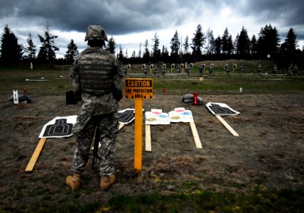 US Navy 100501-N-6538W-024 Aviation Ordnanceman Gabriel Prophet watches as Sailors qualify on an M-16 rifle short-range training course