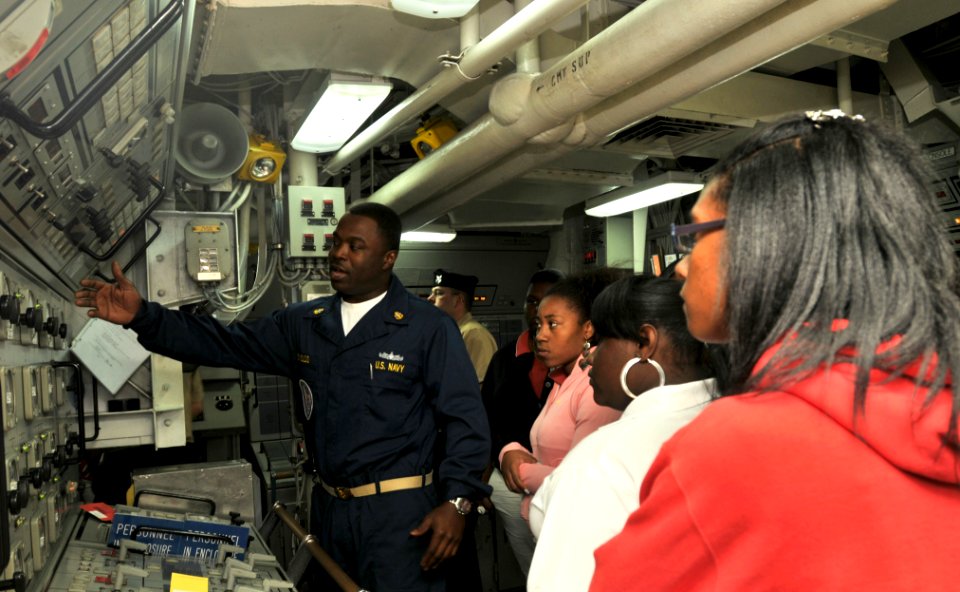 US Navy 100427-N-5812W-001 Chief Gas Turbine System Technician (Mechanical) Gregory Reynolds explains the propulsion control console to members of the Women of Tomorrow Mentor and Scholarship Program
