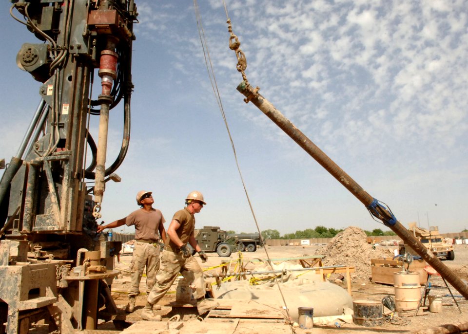 US Navy 100427-N-8816D-105 Equipment Operator 1st Class Jose Martinez, left, and Construction Mechanic 3rd Class Lucas McCleery