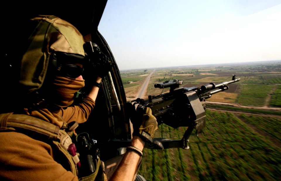 US Navy 100427-N-0879R-038 Chief Naval Aircrewman Dave Allen mans the starboard gun aboard an HH-60H Sea Hawk helicopter