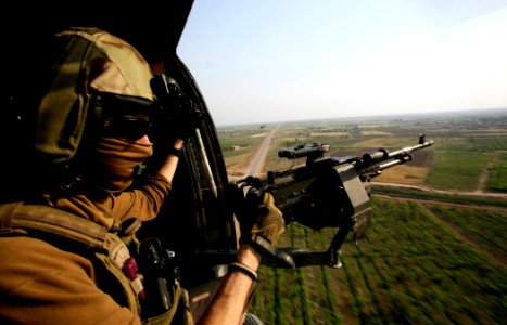 US Navy 100427-N-0879R-038 Chief Naval Aircrewman Dave Allen mans the starboard gun aboard an HH-60H Sea Hawk helicopter photo