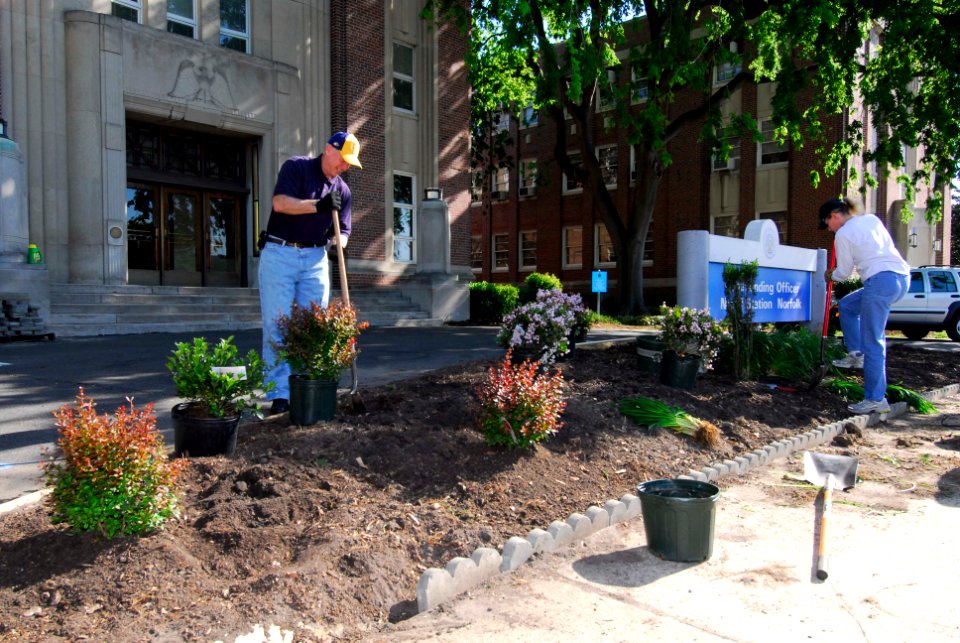 US Navy 100430-N-3154P-013 Capt. Kelly M. Johnson, commanding officer of Naval Station Norfolk, and Capt. Mary M. Jackson, executive officer of Naval Station Norfolk, plant flowers and bushes as part of clean the station day at