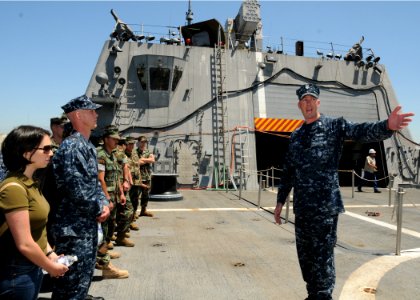 US Navy 100503-N-2259P-015 Engineman 1st Class Chris Richars briefs visitors about the littoral combat ship USS Freedom (LCS 1) photo